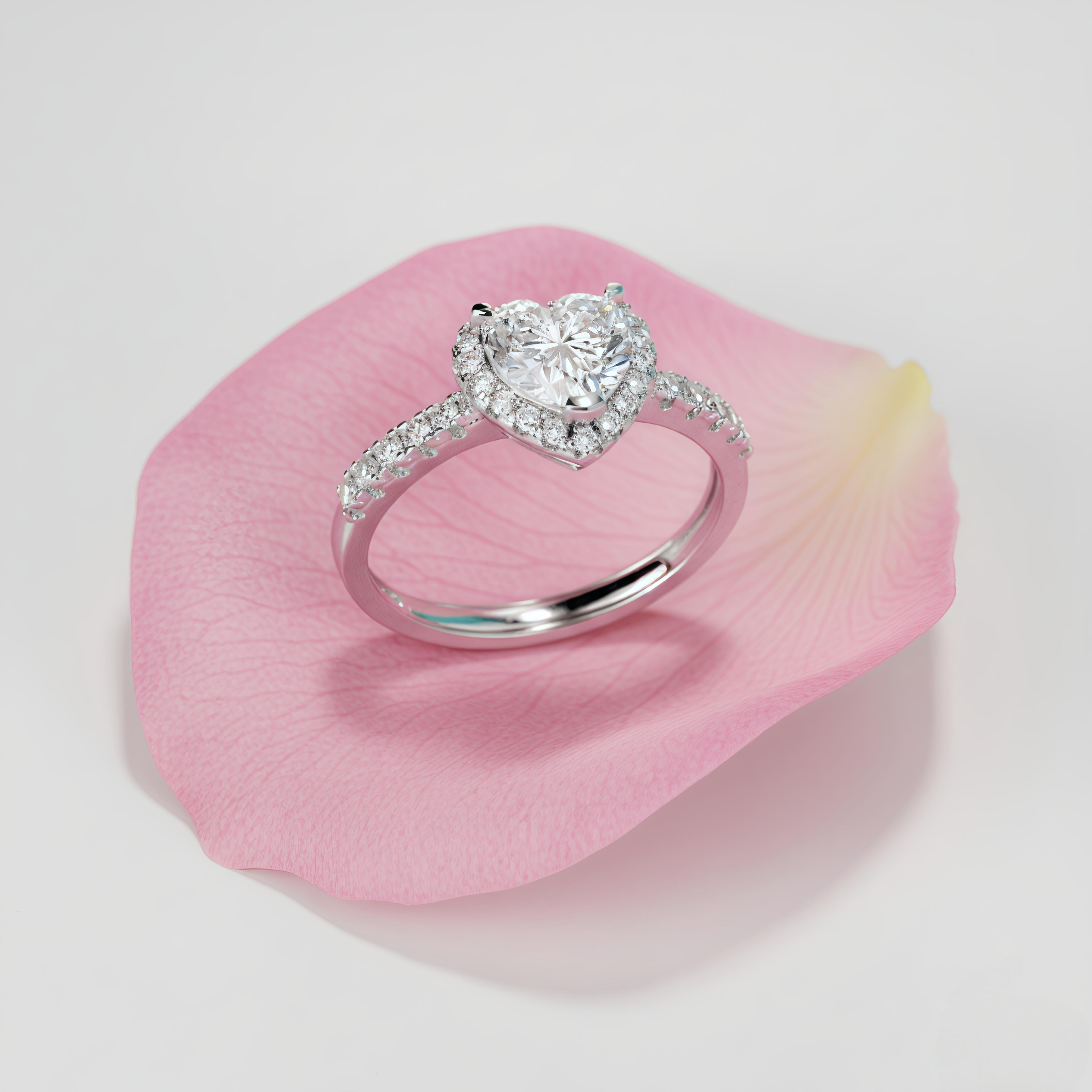 Diamond ring on a pink petal with a light gray background