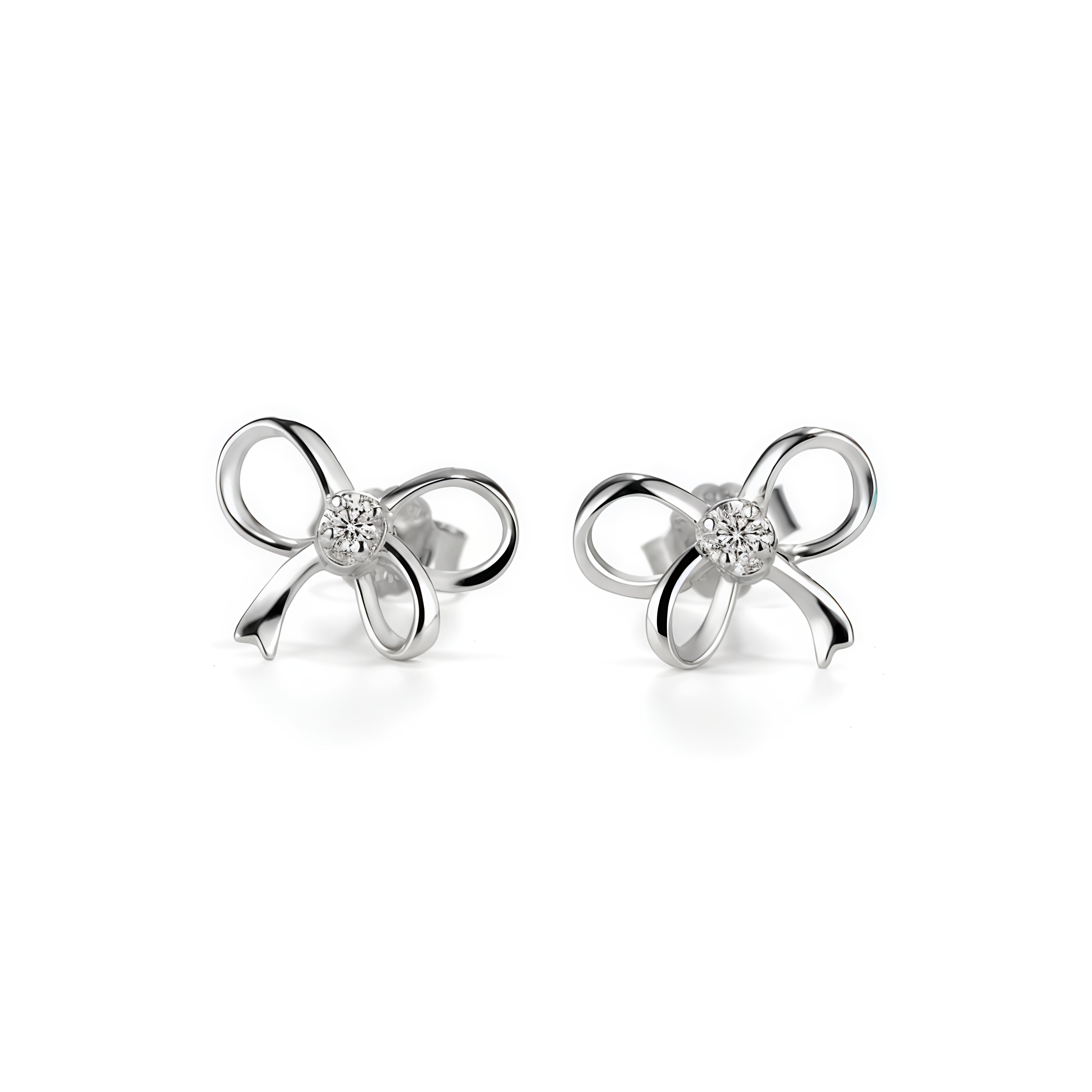 Silver bow-shaped earrings with small diamonds on a white background
