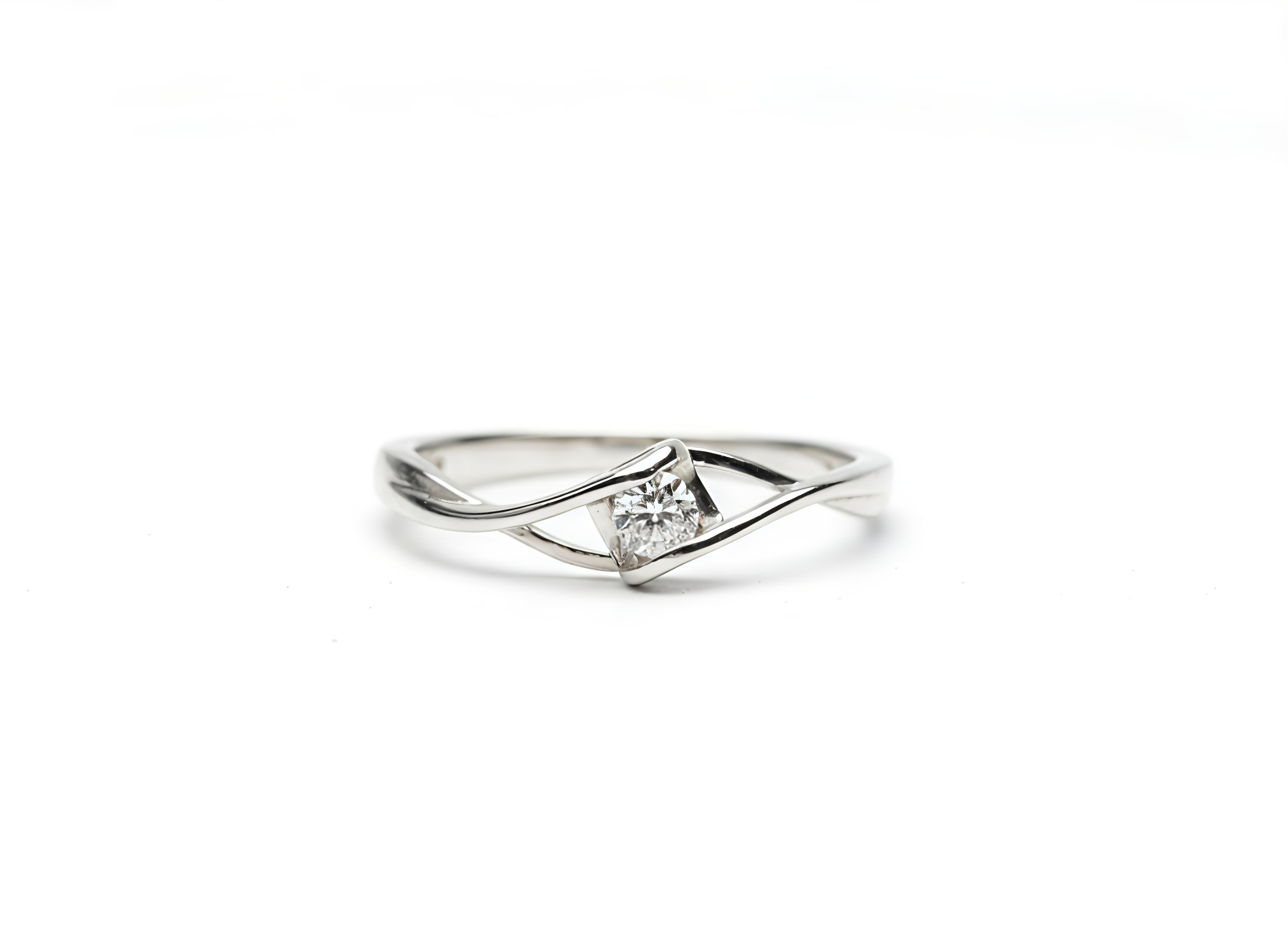 Silver ring with a diamond on a white background