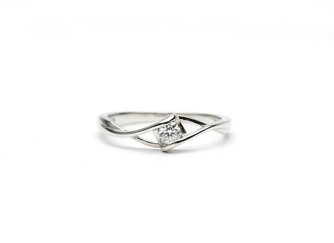 Silver ring with a diamond on a white background