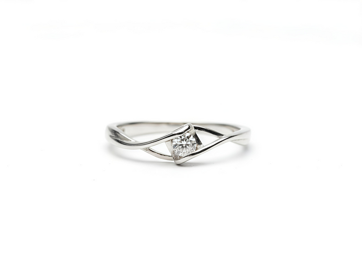 Silver ring with a diamond on a white background